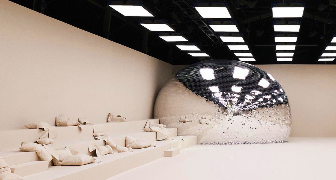 Cream sculptural hall with a mirrored dome, Acne Studios SS24, Val-de-Grâce, Paris.