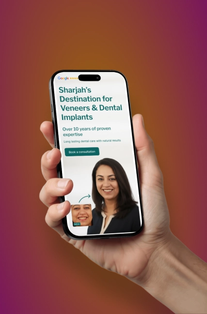 Hand holding a smartphone displaying a dental clinic website with the headline 'Sharjah’s Destination for Veneers & Dental Implants,' mentioning over 10 years of proven expertise, a button labeled 'Book a consultation,' and a before-and-after photo of a smiling woman.