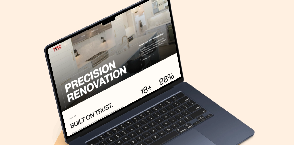 Laptop displaying a home renovation website featuring a modern kitchen background with text reading 'PRECISION RENOVATION,' 'BUILT ON TRUST,' '18+,' and '98%'.