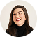 Portrait of a smiling woman with long dark hair wearing a black turtleneck.