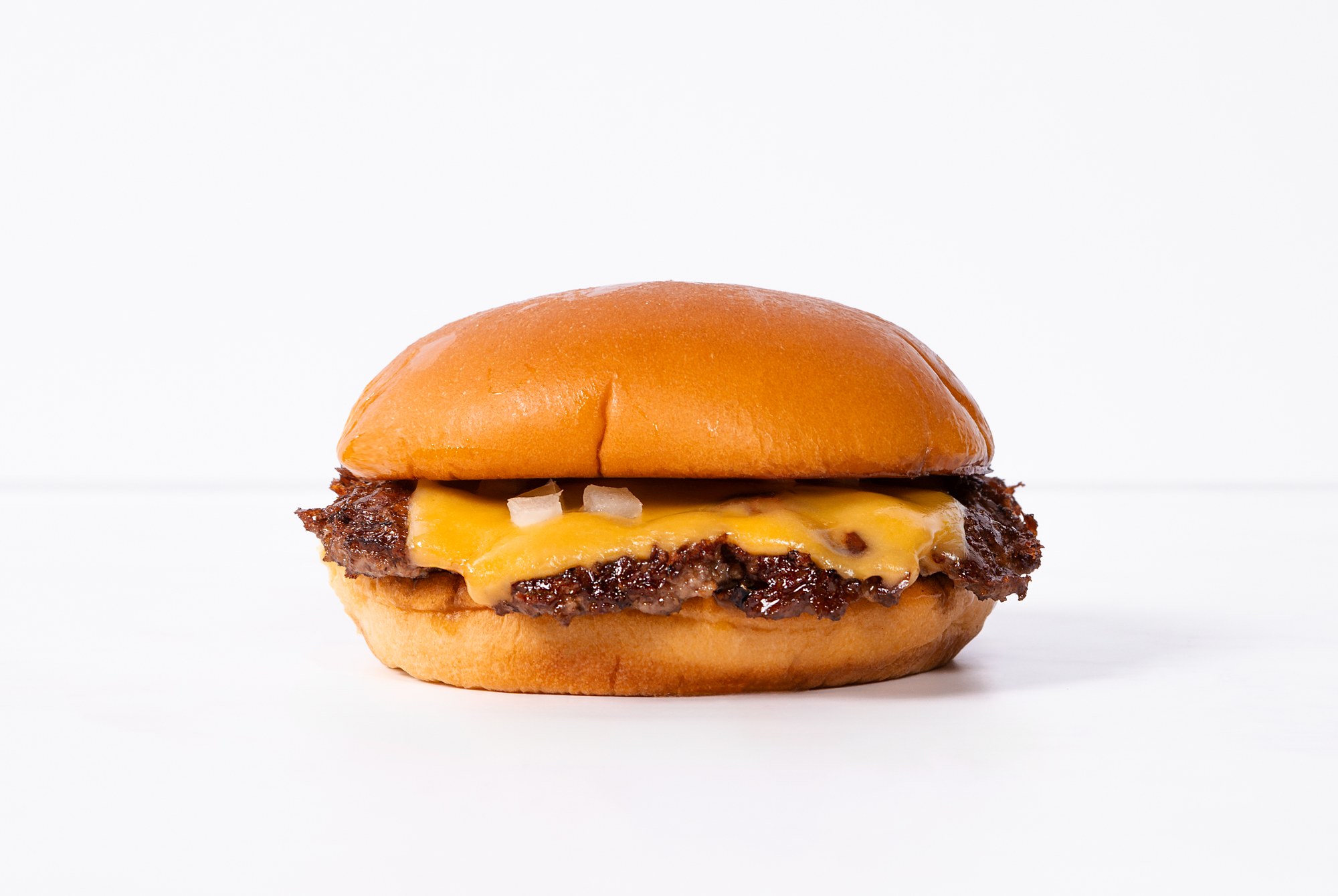 The Classic single smash burger with American cheese and diced onions